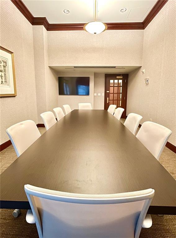 dining area with carpet flooring, baseboards, and ornamental molding