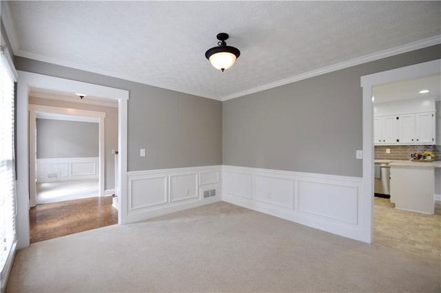 5040 Puritan Dr, Sugar Hill, GA 30518 - unfurnished room with light colored carpet, crown molding, and a wainscoted wall