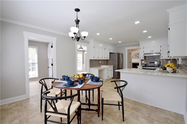 5040 Puritan Dr, Sugar Hill, GA 30518 - dining space with ornamental molding, recessed lighting, and a chandelier