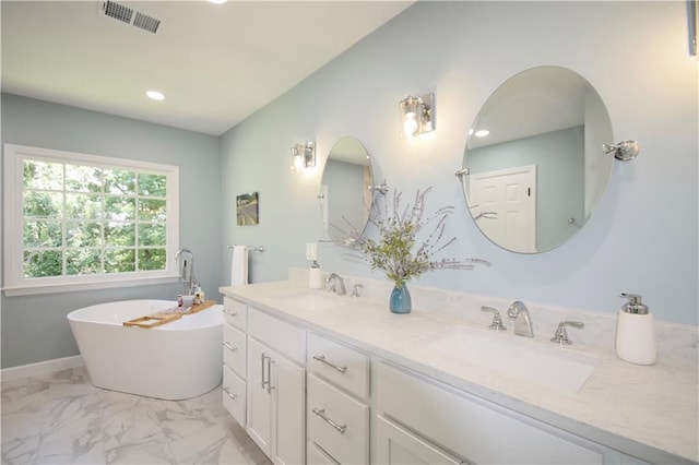 5040 Puritan Dr, Sugar Hill, GA 30518 - full bathroom with double vanity, a freestanding tub, marble finish floors, and recessed lighting