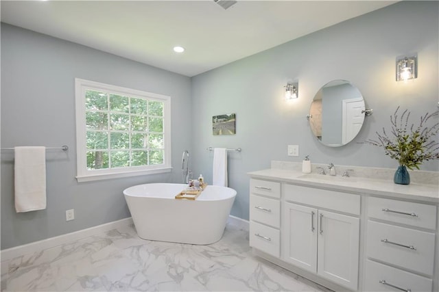 5040 Puritan Dr, Sugar Hill, GA 30518 - bathroom featuring marble look tiles, vanity, a freestanding bath, and recessed lighting