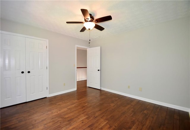 5040 Puritan Dr, Sugar Hill, GA 30518 - unfurnished bedroom with wood finished floors, a closet, and a ceiling fan
