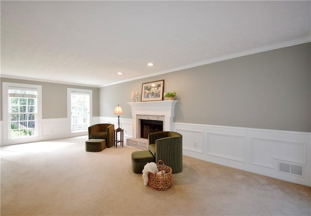 5040 Puritan Dr, Sugar Hill, GA 30518 - living area featuring carpet, crown molding, a brick fireplace, wainscoting, and a decorative wall