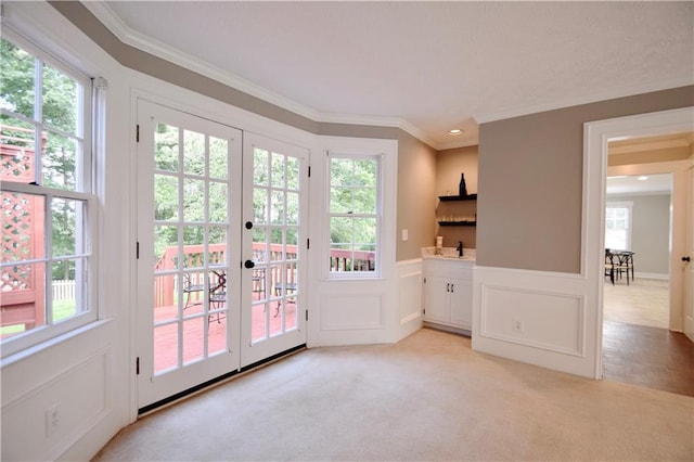 5040 Puritan Dr, Sugar Hill, GA 30518 - doorway with french doors, ornamental molding, healthy amount of natural light, light colored carpet, and a decorative wall