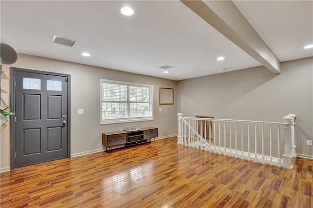 entrance foyer featuring recessed lighting, visible vents, baseboards, and wood finished floors