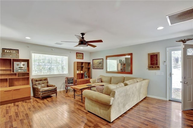 living room featuring plenty of natural light, visible vents, wood finished floors, and recessed lighting