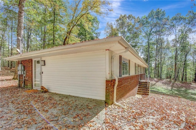 view of side of home featuring brick siding