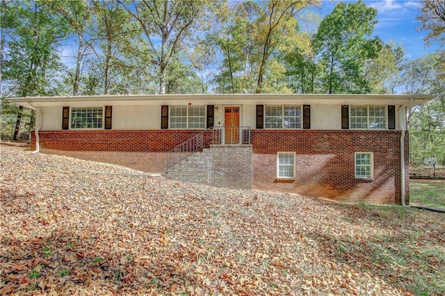 ranch-style home featuring brick siding