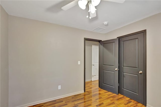 unfurnished bedroom featuring visible vents, a ceiling fan, light wood-style flooring, and baseboards