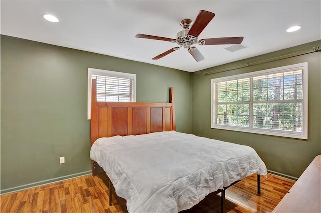 bedroom featuring recessed lighting, visible vents, baseboards, and wood finished floors