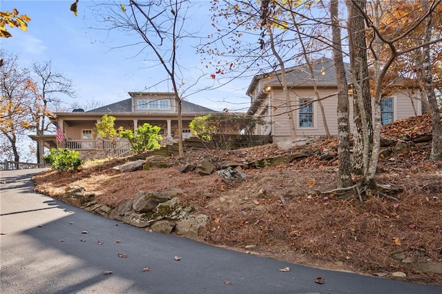 view of property exterior featuring covered porch