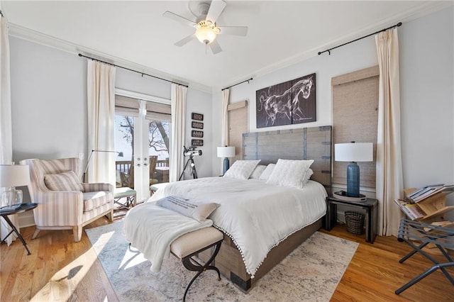 bedroom featuring access to exterior, ceiling fan, french doors, hardwood / wood-style floors, and ornamental molding