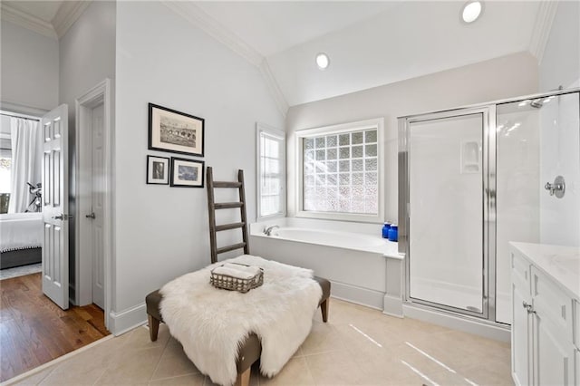 bathroom featuring plus walk in shower, wood-type flooring, vanity, and ornamental molding