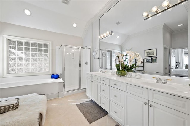 bathroom featuring vanity, a healthy amount of sunlight, vaulted ceiling, and shower with separate bathtub