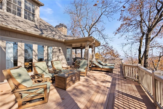 wooden terrace featuring a fire pit