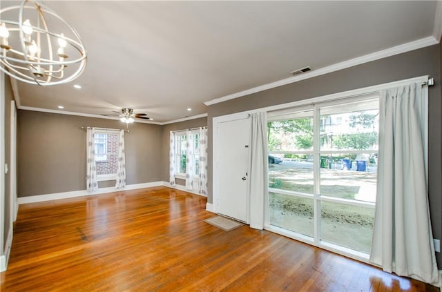 interior space with crown molding, hardwood / wood-style floors, and ceiling fan with notable chandelier