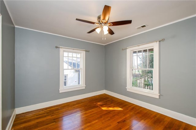 unfurnished room featuring ornamental molding, hardwood / wood-style flooring, ceiling fan, and a wealth of natural light