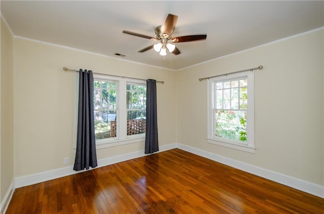 empty room with crown molding, wood-type flooring, and ceiling fan