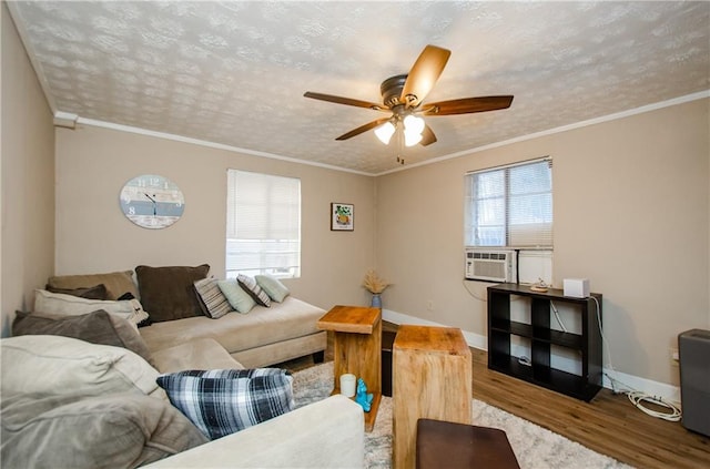 living room featuring light hardwood / wood-style floors, crown molding, cooling unit, and ceiling fan