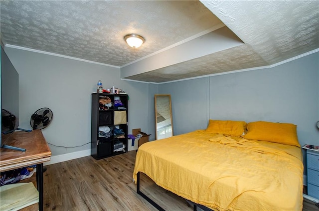 bedroom with ornamental molding, hardwood / wood-style floors, and a textured ceiling