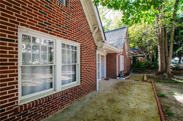 view of property exterior with a patio area