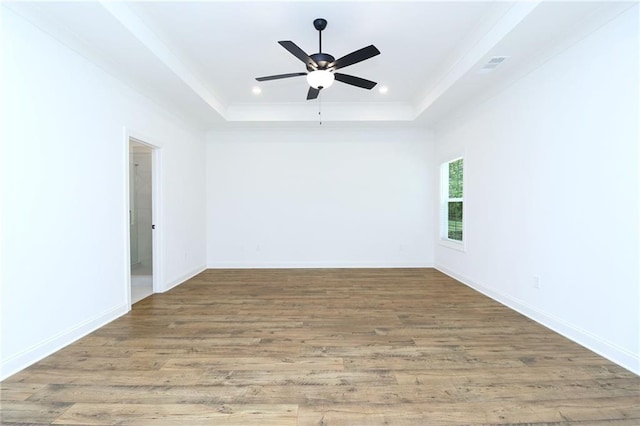 2113 Ella Springs Dr, Covington, GA 30014 - unfurnished room featuring a raised ceiling, wood finished floors, ornamental molding, ceiling fan, and recessed lighting
