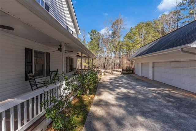 view of property exterior featuring a ceiling fan, fence, and a garage