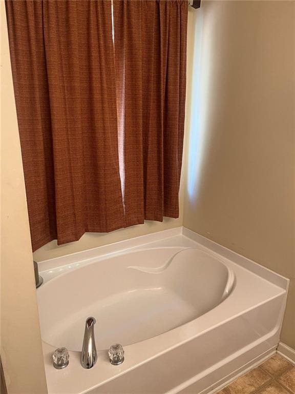 bathroom with a bathtub and tile patterned floors