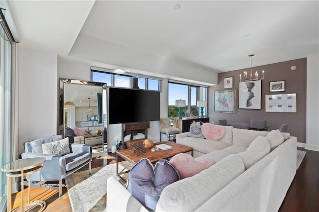 living room with wood-type flooring and a chandelier