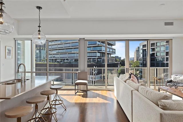 living room featuring sink and light hardwood / wood-style floors