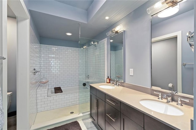 bathroom featuring tiled shower, tile patterned flooring, toilet, and vanity