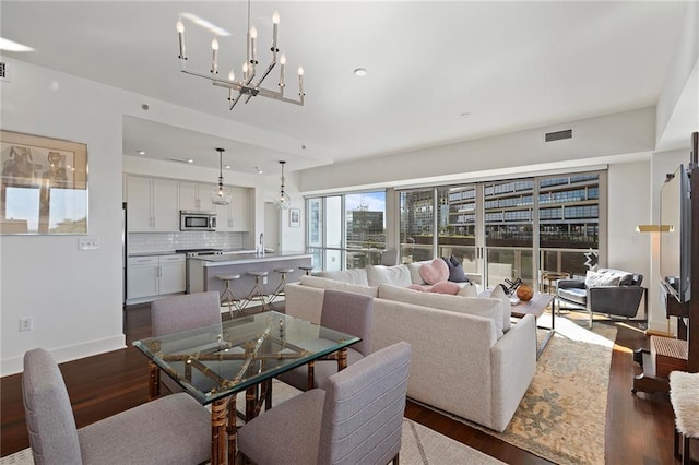 dining room featuring dark hardwood / wood-style floors and a chandelier