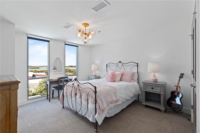 carpeted bedroom featuring a notable chandelier