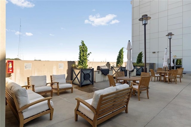 view of patio with grilling area and an outdoor hangout area