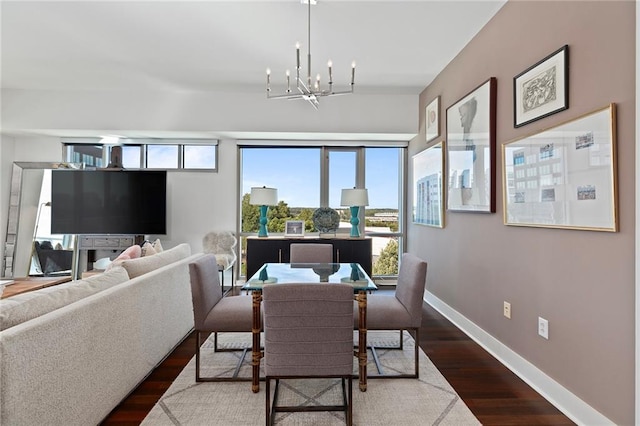 dining space with a notable chandelier and dark hardwood / wood-style floors