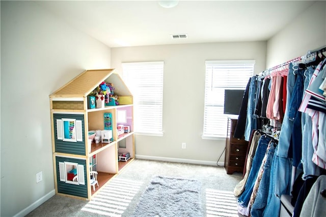 interior space with carpet floors, baseboards, and visible vents