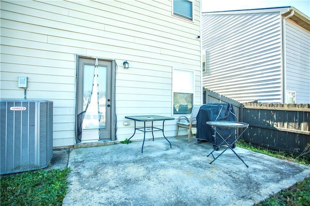 view of patio featuring cooling unit and fence