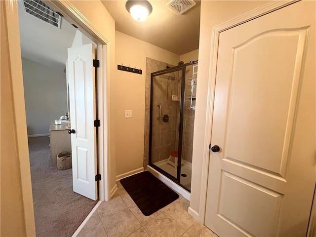 bathroom with a stall shower, visible vents, and tile patterned floors