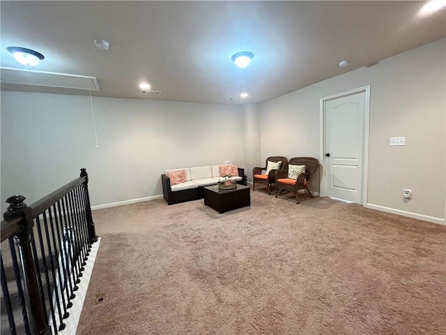 living area with attic access, baseboards, and carpet flooring