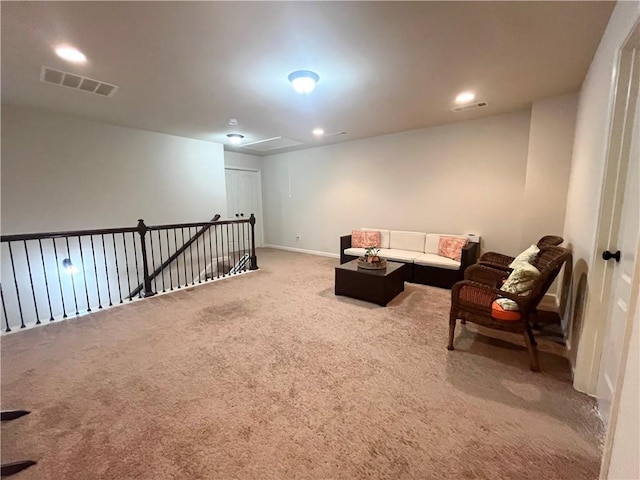 carpeted living room with attic access, visible vents, and recessed lighting