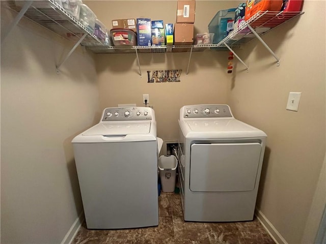 laundry area featuring laundry area, washer and clothes dryer, and baseboards