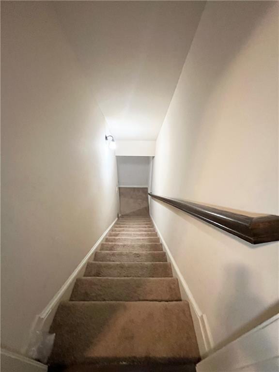 staircase featuring baseboards