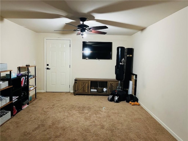 carpeted living room with ceiling fan and baseboards