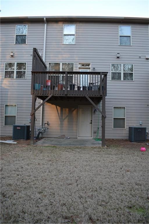 back of property with a deck, central AC, and a patio