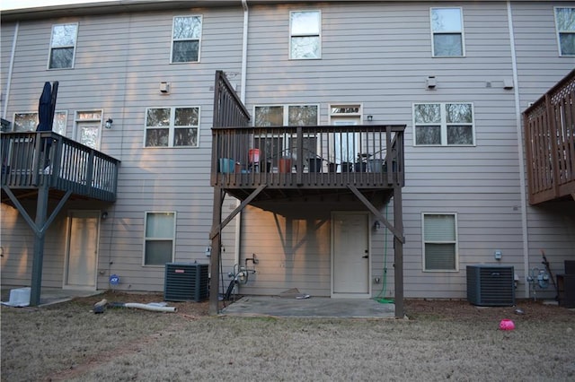 rear view of house with a deck and central AC