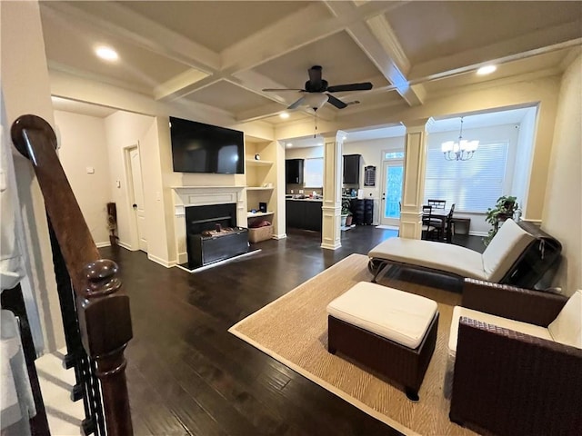 living area with coffered ceiling, a fireplace, decorative columns, and dark wood-style floors