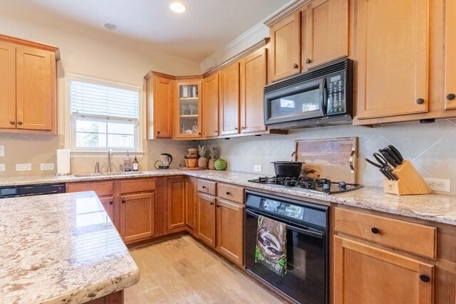 6426 Queens Court Trce Unit 7, Mableton, GA 30126 - kitchen with black appliances, backsplash, glass insert cabinets, light wood finished floors, and light stone counters