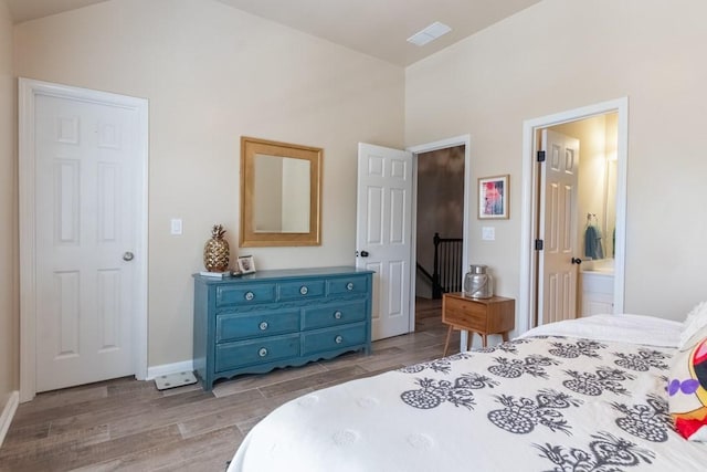 6426 Queens Court Trce Unit 7, Mableton, GA 30126 - bedroom featuring wood finished floors, lofted ceiling, and connected bathroom