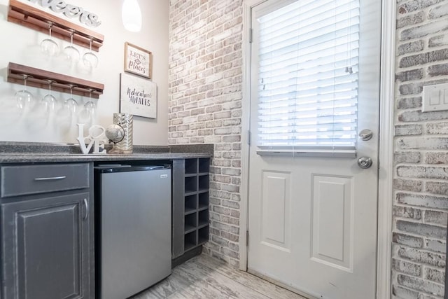 6426 Queens Court Trce Unit 7, Mableton, GA 30126 - indoor dry bar with refrigerator, light wood-type flooring, and brick wall