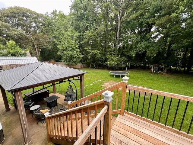 124 Dockside Downs Dr, Woodstock, GA 30189 - wooden terrace with a trampoline, a yard, and a playground